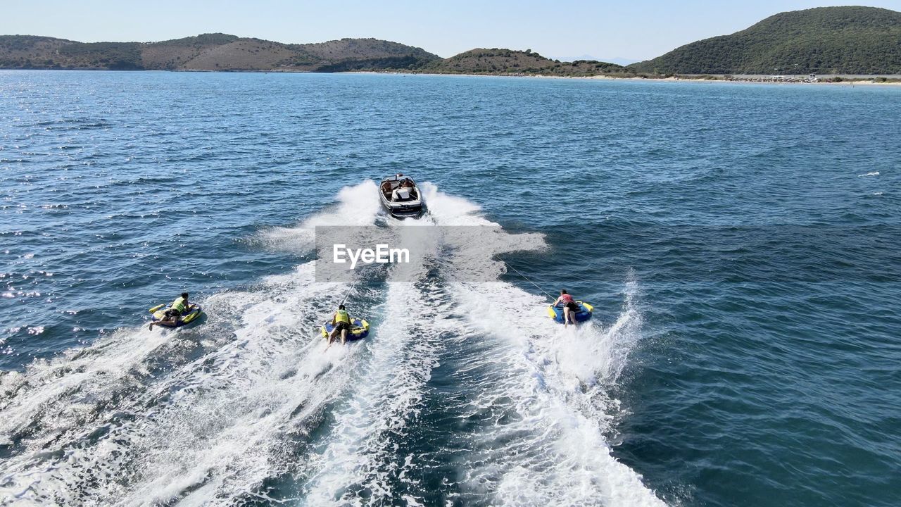 PEOPLE ON BOAT IN SEA