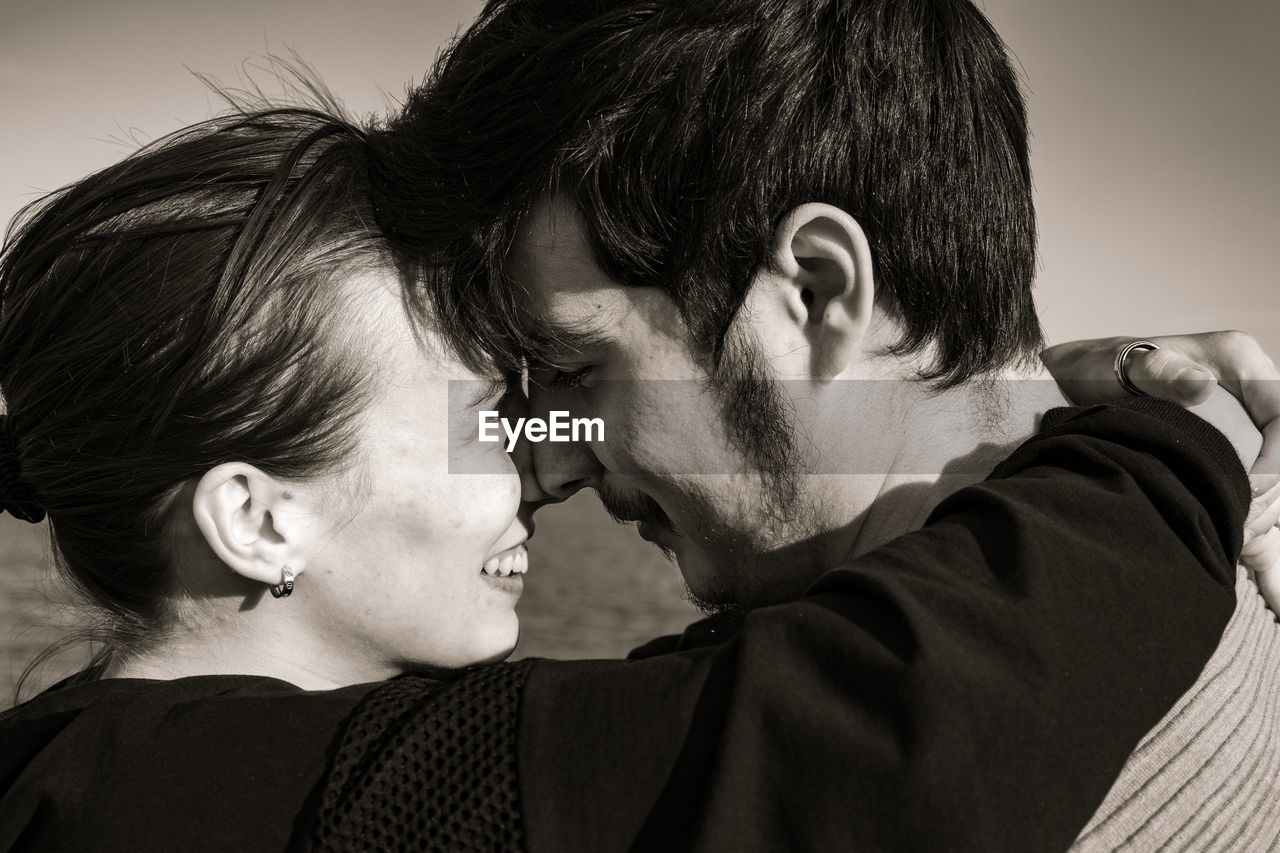 emotion, adult, two people, men, positive emotion, love, togetherness, black and white, romance, portrait, women, embracing, monochrome, headshot, happiness, person, young adult, affectionate, monochrome photography, bonding, smiling, female, lifestyles, portrait photography, black, ceremony, human face, friendship, kissing, cheerful, child