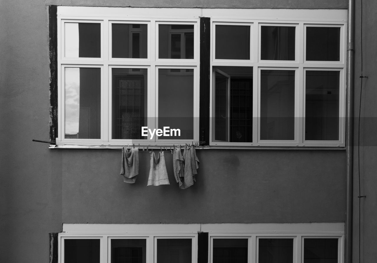 Laundry hanging on clothesline by window