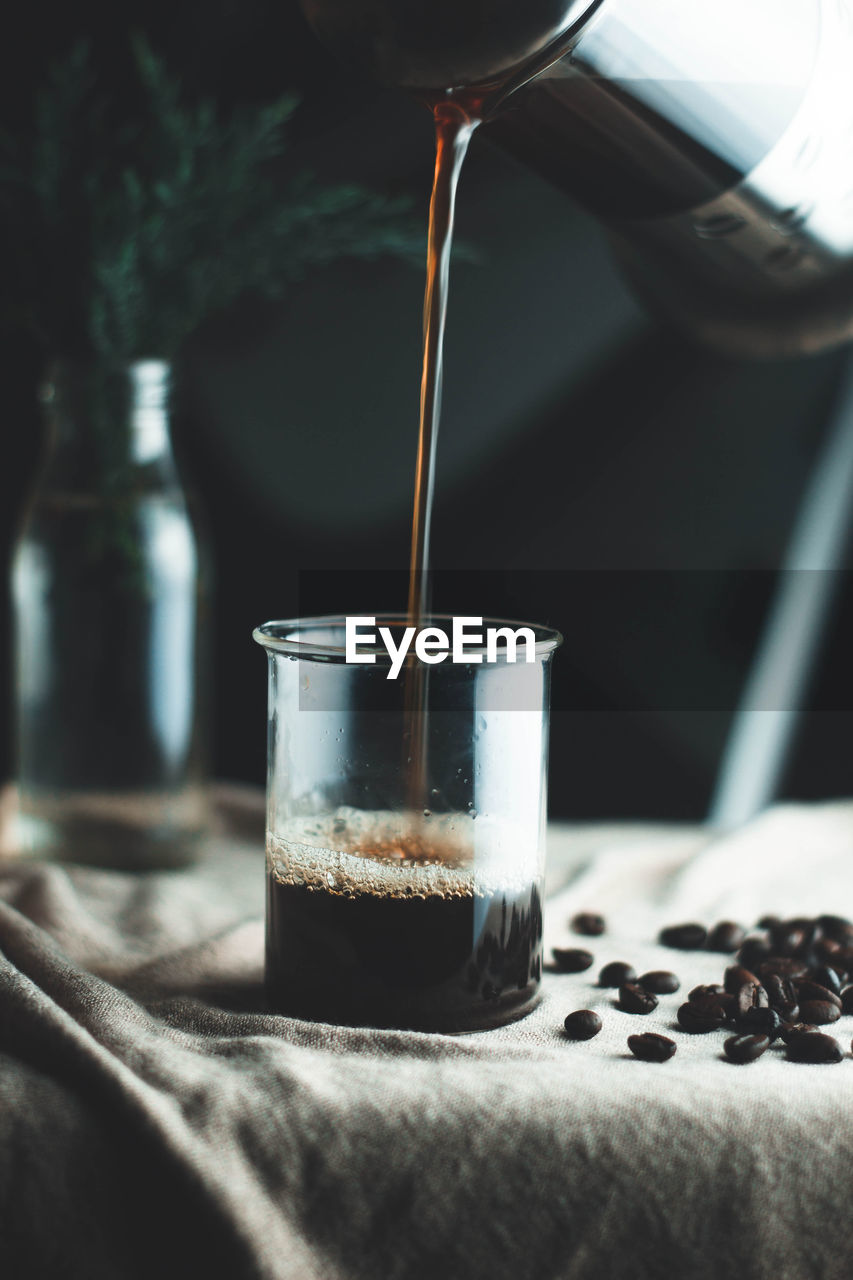 CLOSE-UP OF COFFEE CUP ON GLASS