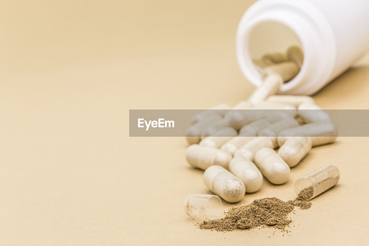 CLOSE-UP OF COFFEE BEANS ON WHITE TABLE