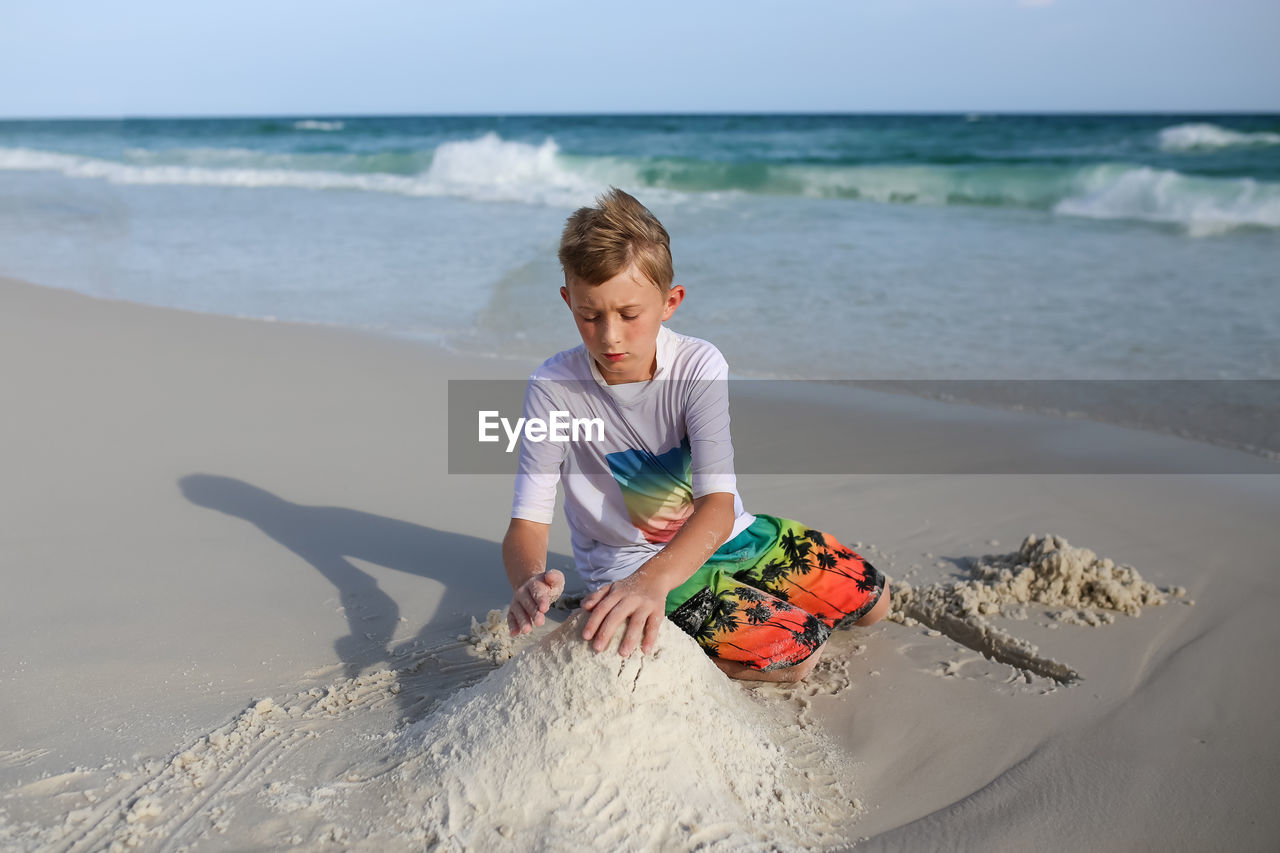 Boy making sandcastle at beach