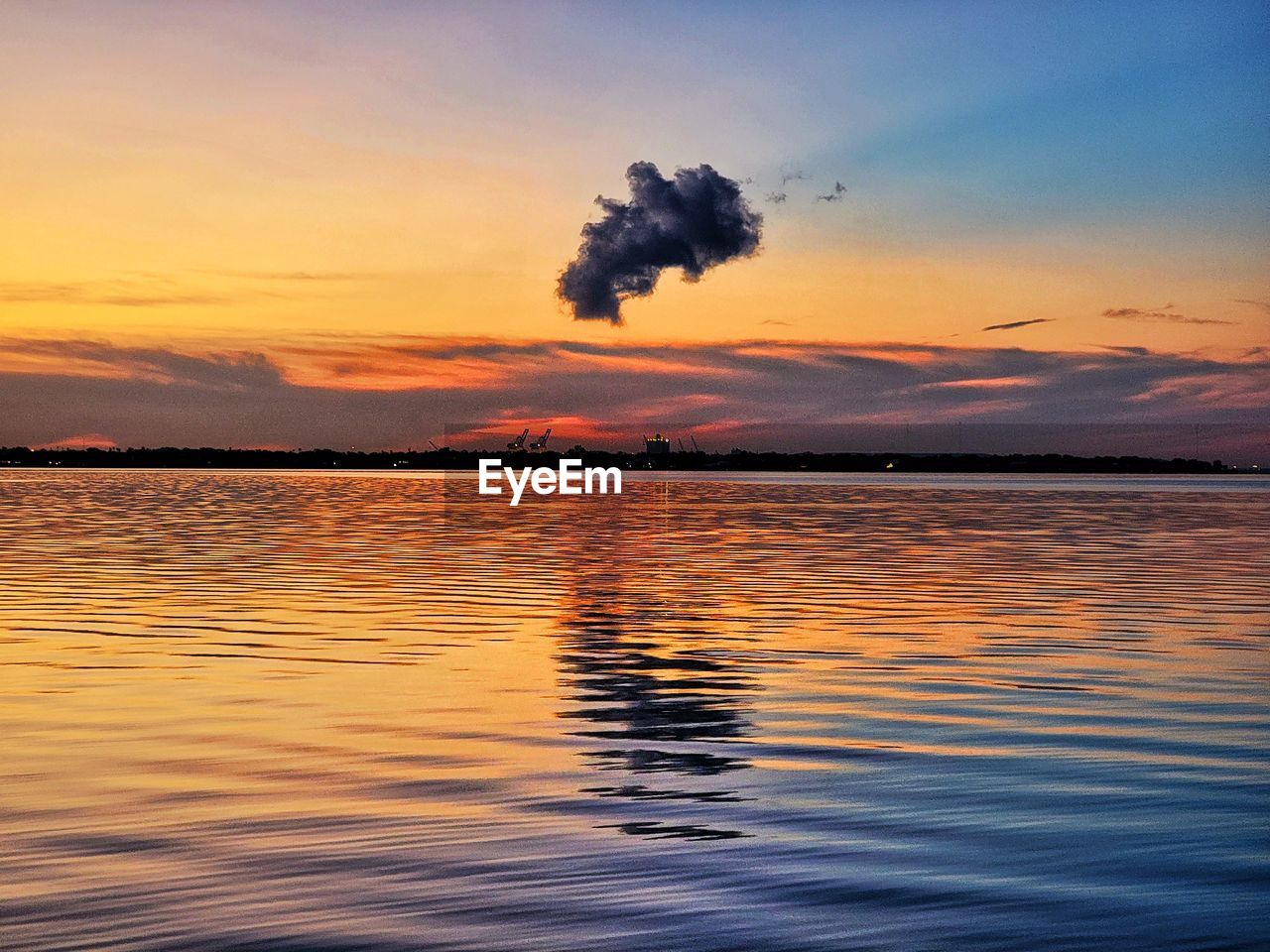 sky, water, sunset, reflection, cloud, sea, beauty in nature, afterglow, nature, dawn, scenics - nature, horizon, tranquility, evening, tranquil scene, environment, no people, ocean, orange color, outdoors, shore, land, silhouette, dramatic sky, idyllic, landscape, wave, travel destinations, rippled, motion, seascape
