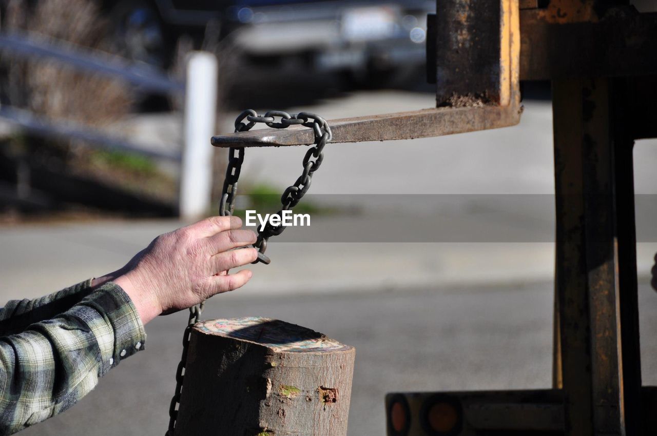 Close-up of hand holding metal