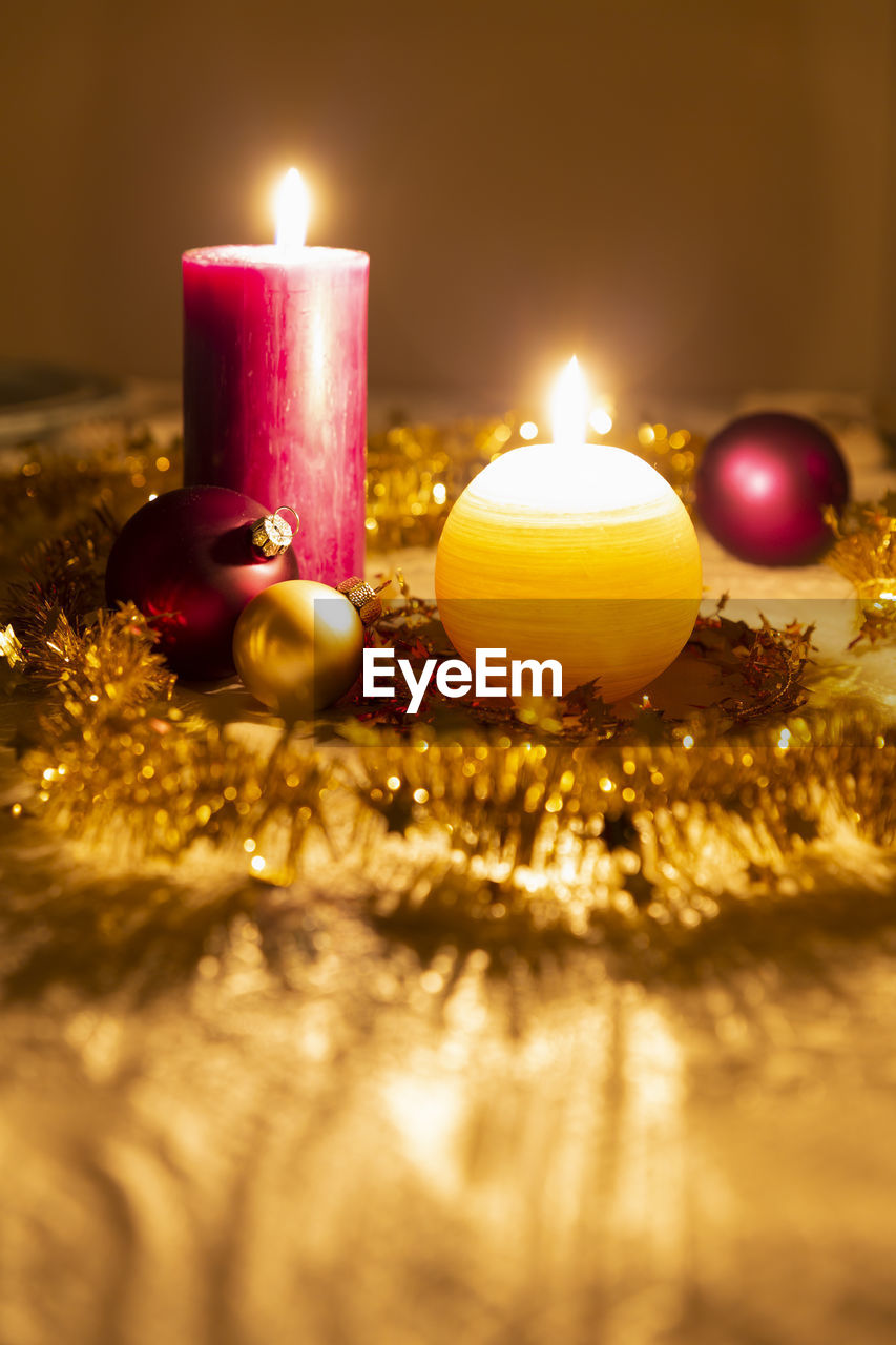 Close-up of illuminated christmas decorations on dining table