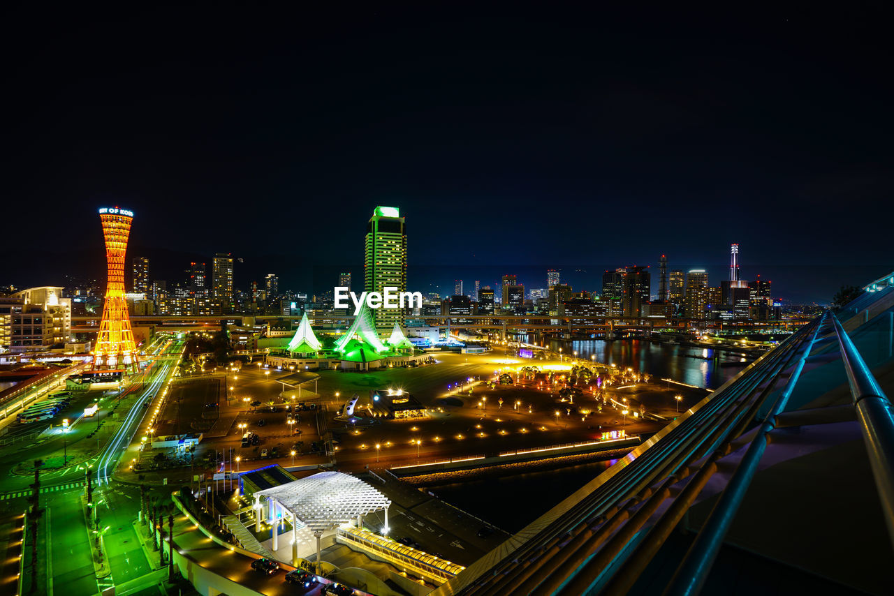 ILLUMINATED BUILDINGS IN CITY AT NIGHT