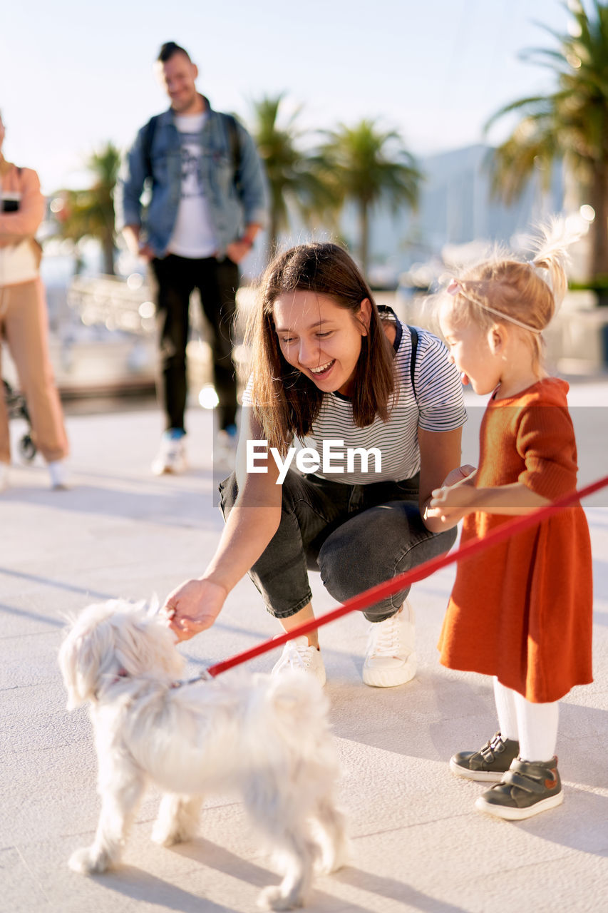 WOMAN WITH DOG ON STREET