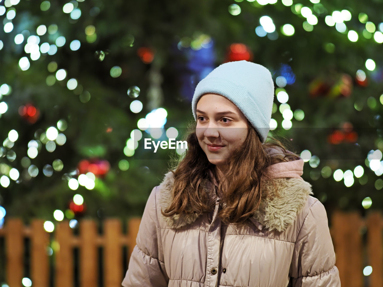 Authentic tenage girl in front of a christmas tree