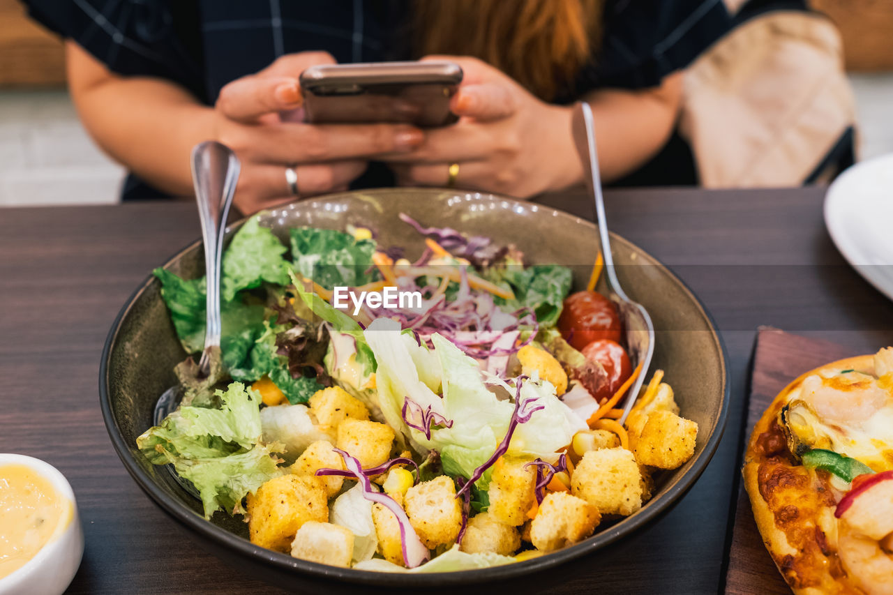 Close-up of man having food on table