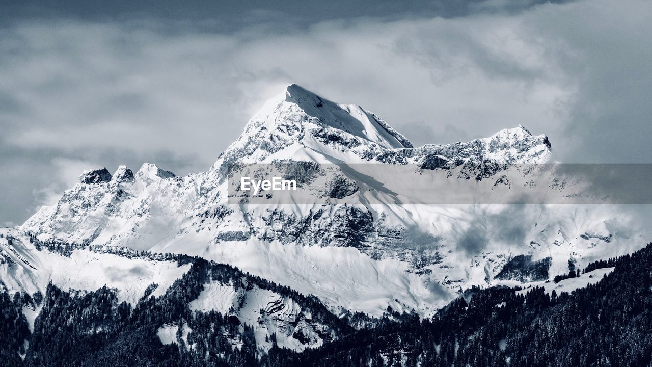 Scenic view of snowcapped mountains against sky