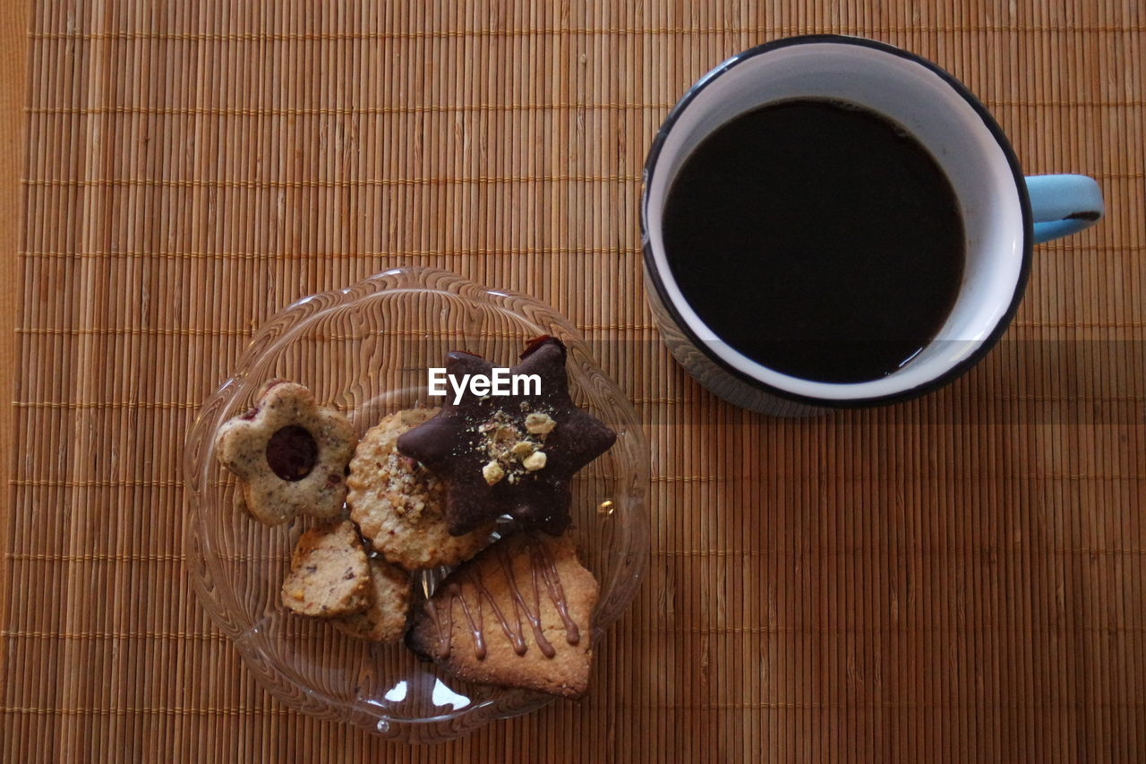 Close-up of cookies and black coffee served on table