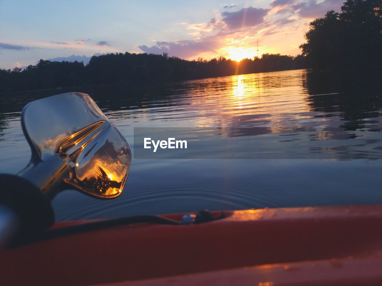 CLOSE-UP OF GLASS AGAINST SUNSET