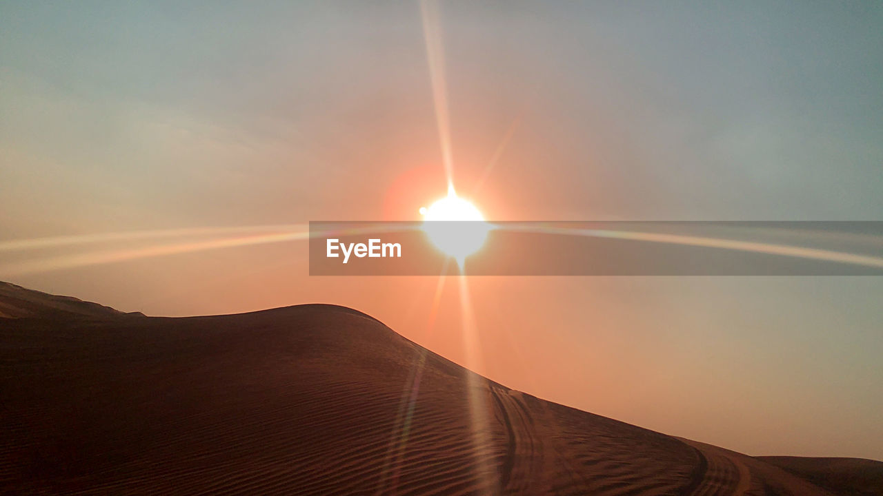 SCENIC VIEW OF MOUNTAIN AGAINST SKY AT SUNSET