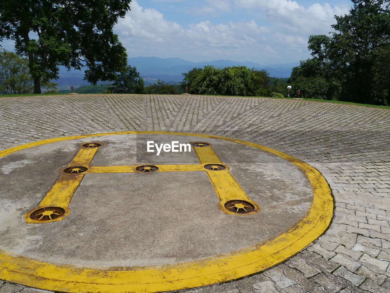 Helipad with trees in background