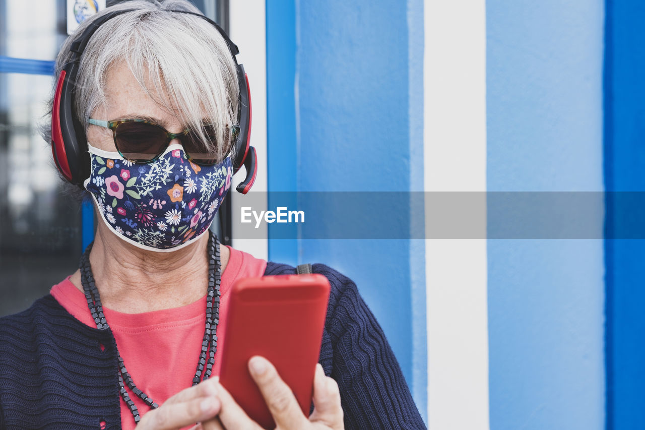 Portrait of woman holding sunglasses