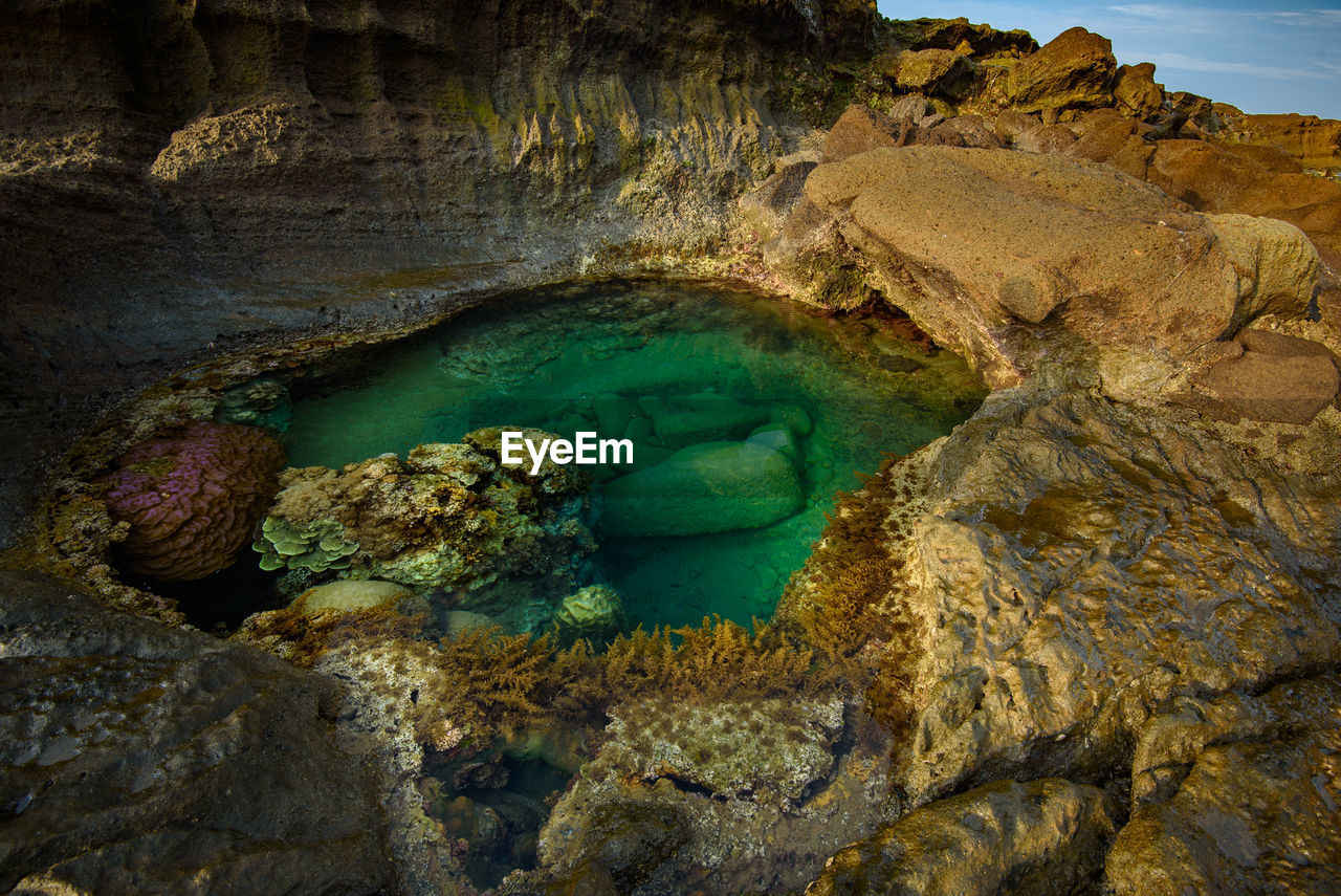 VIEW OF ROCK FORMATION IN SEA