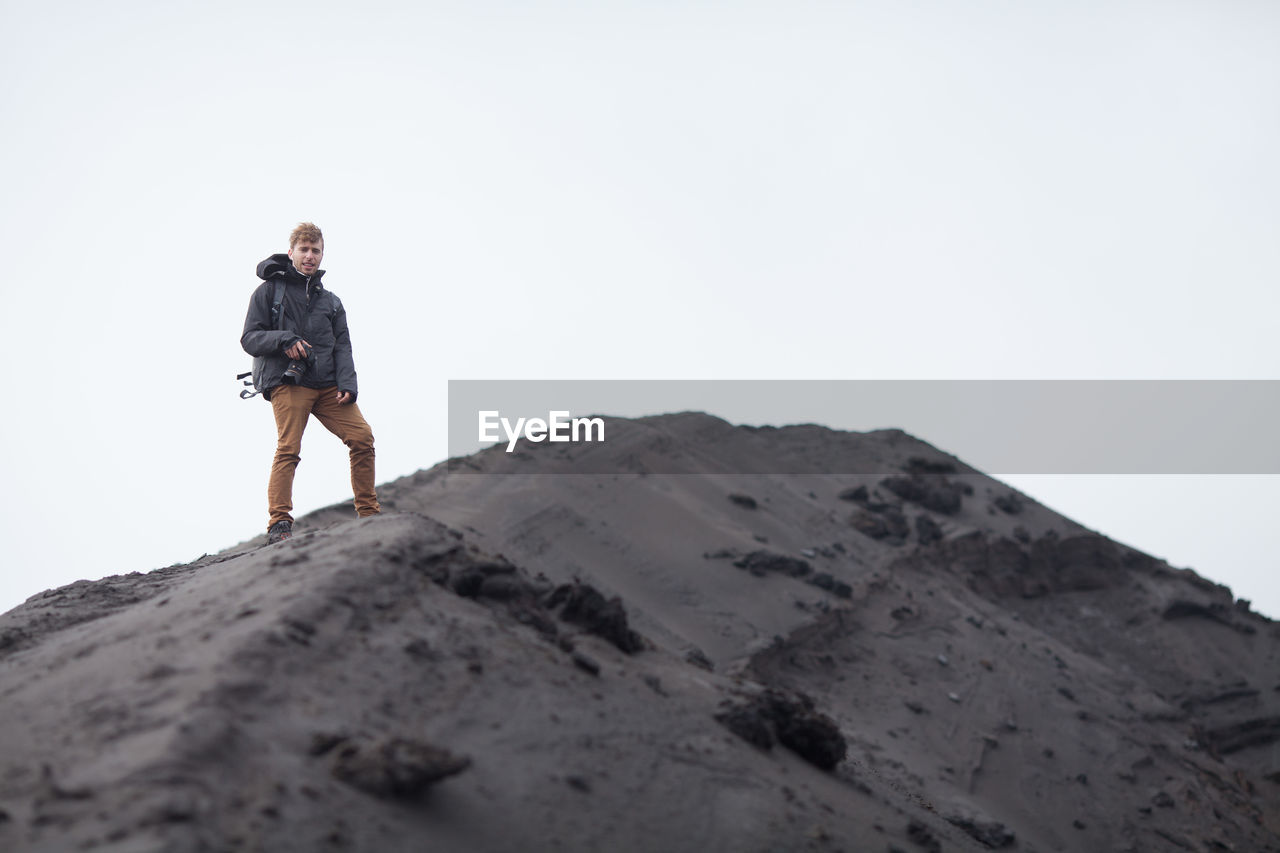 Man standing on a sand dune