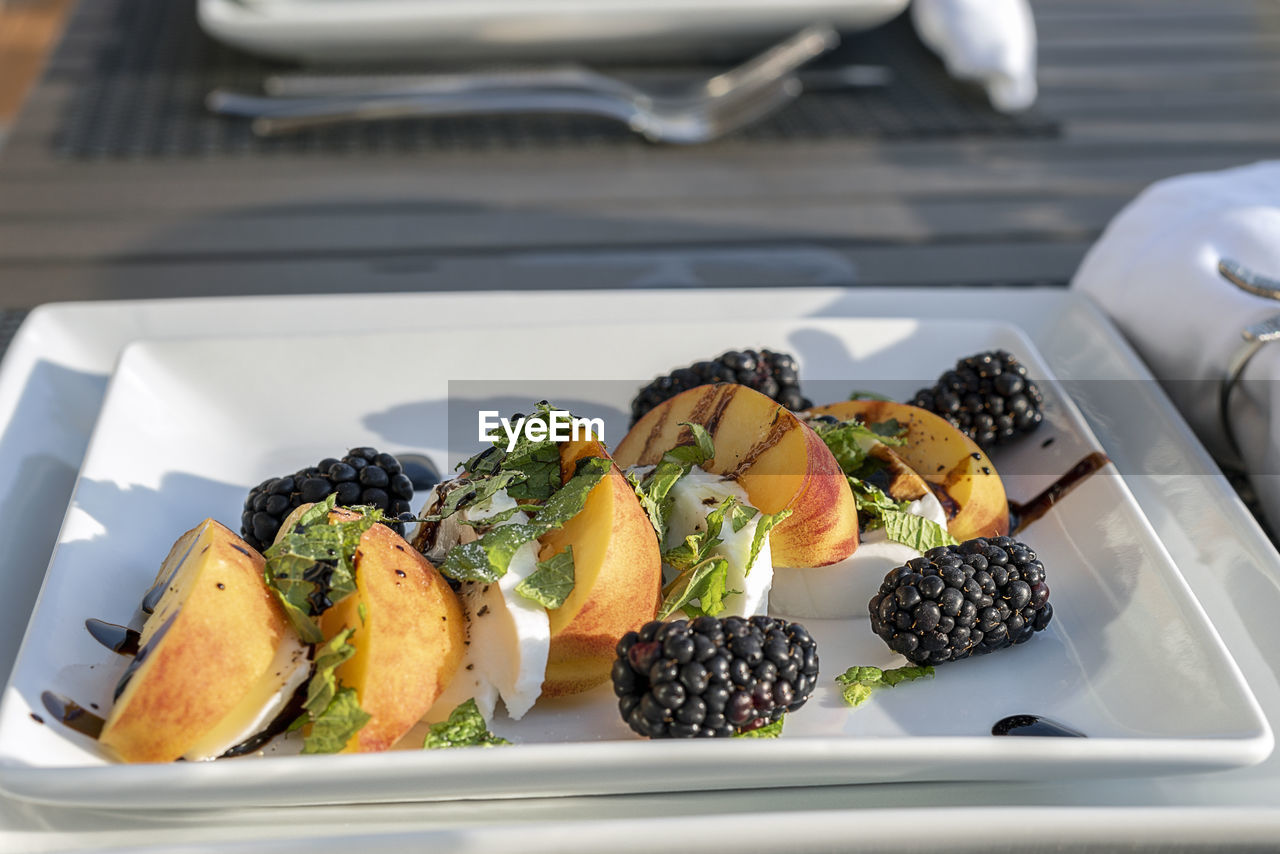 High angle view of fruit salad served in plate on table