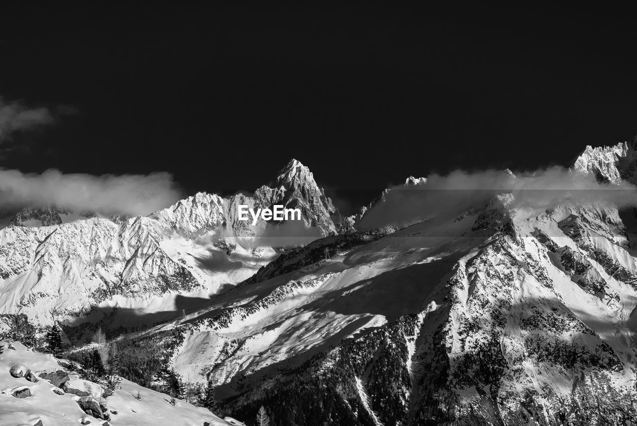 Low angle view of snowcapped mountain against sky