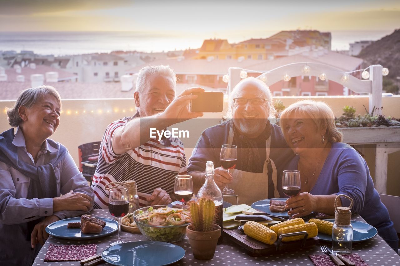 GROUP OF PEOPLE SITTING AT RESTAURANT