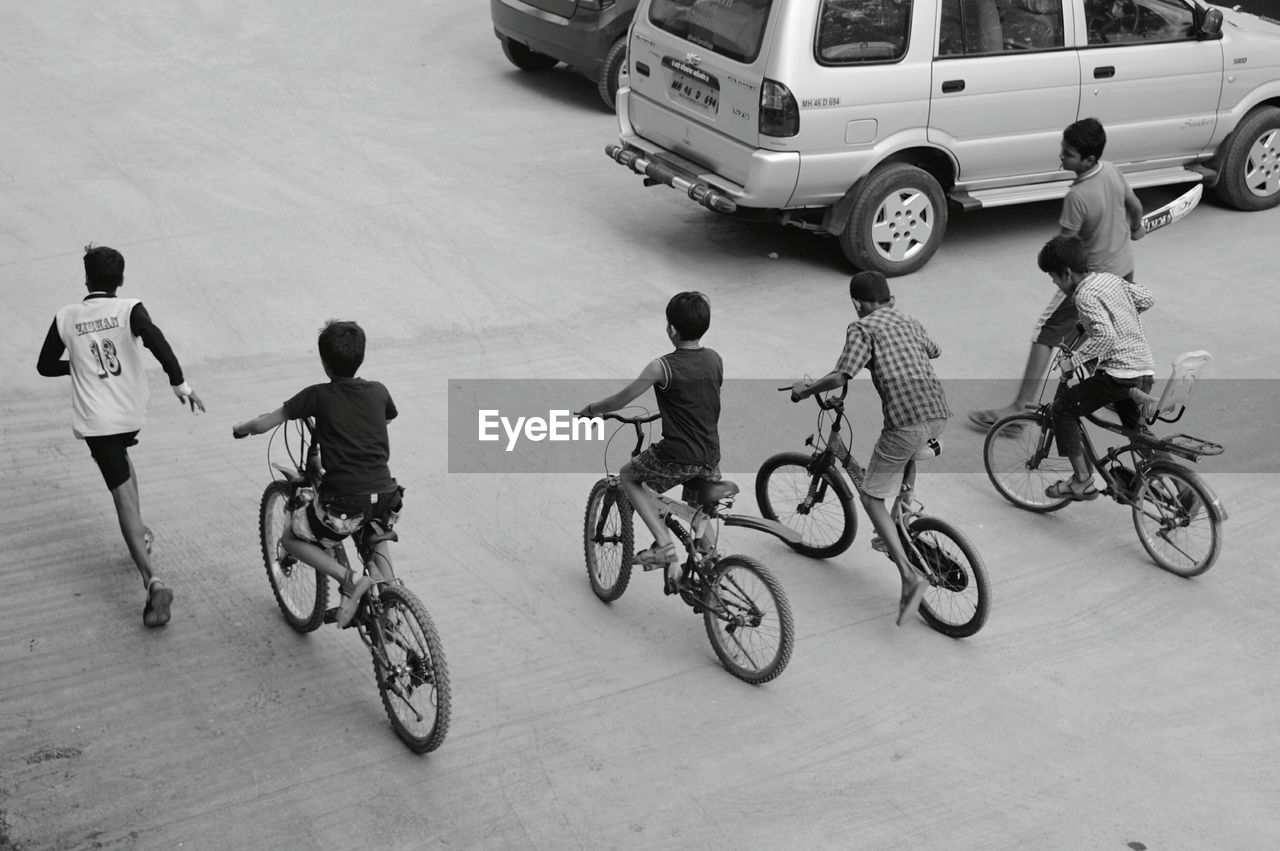 HIGH ANGLE VIEW OF PEOPLE RIDING BICYCLES