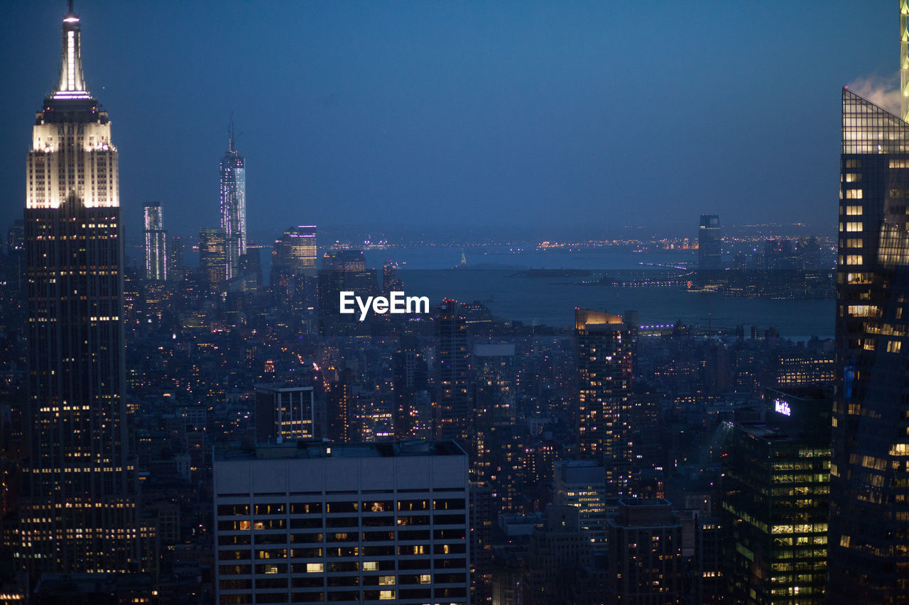 High angle view of buildings lit up at night