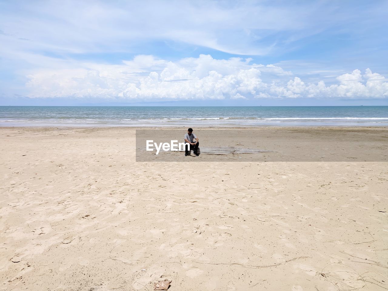 Man on beach against sky