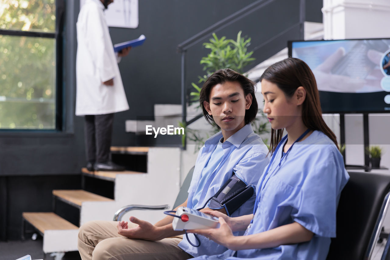 portrait of smiling female doctor using digital tablet in office