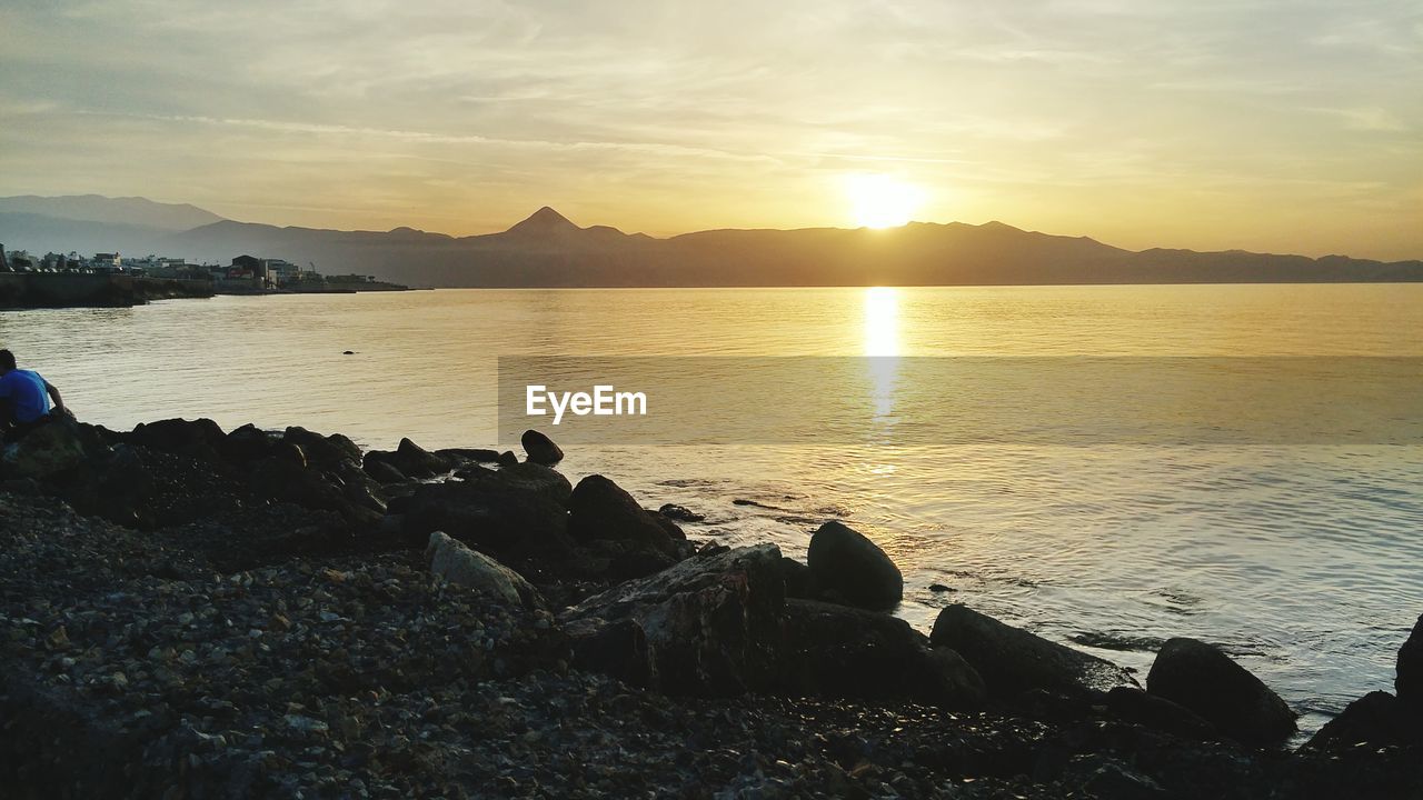 SCENIC VIEW OF SUNSET OVER SEA