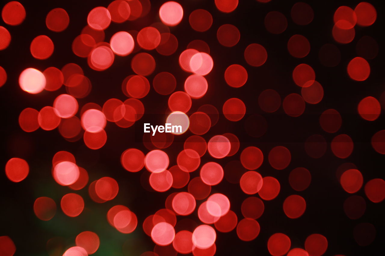 Defocused image of illuminated red lights at night