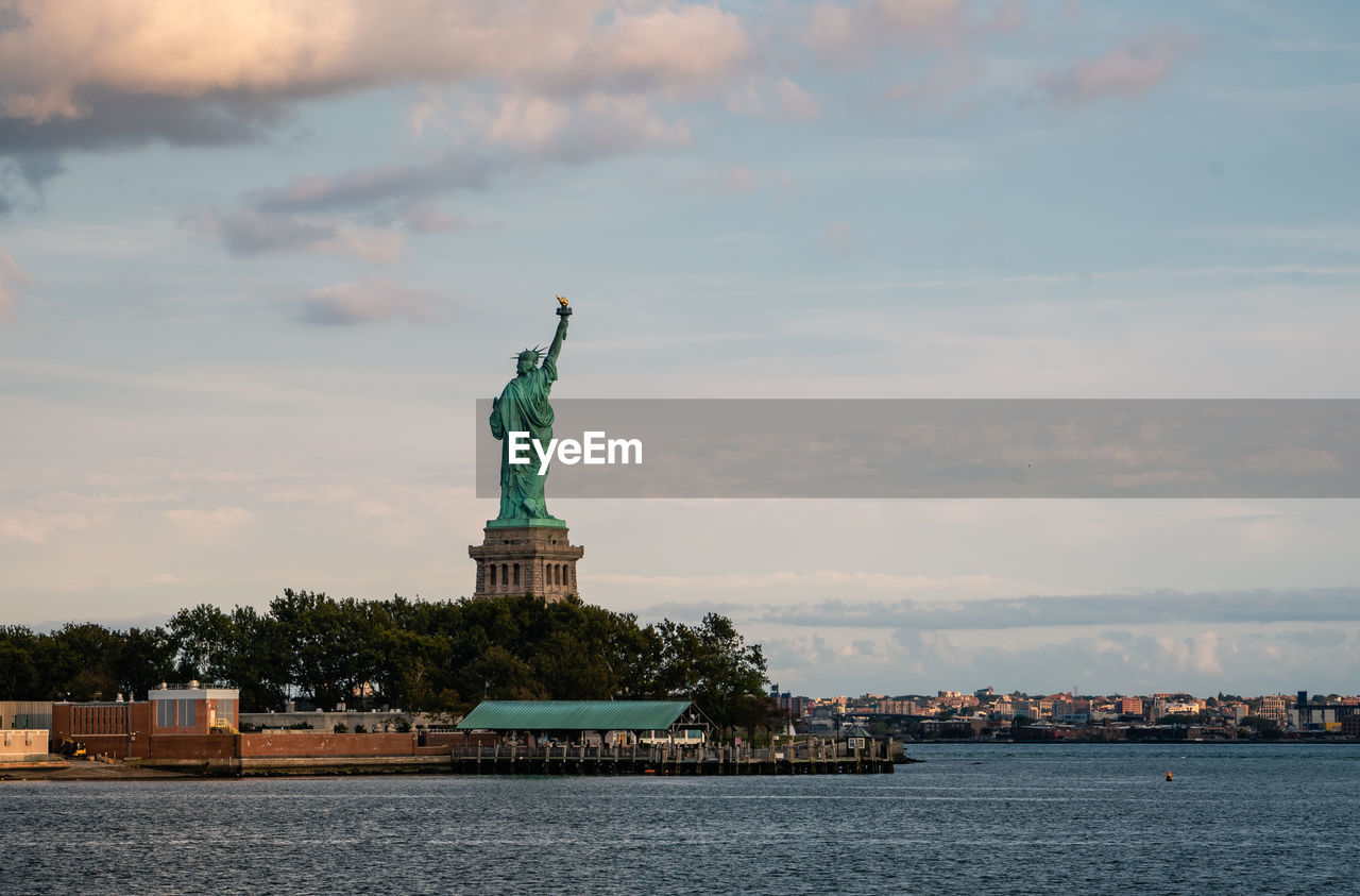 Statue of liberty against cloudy sky