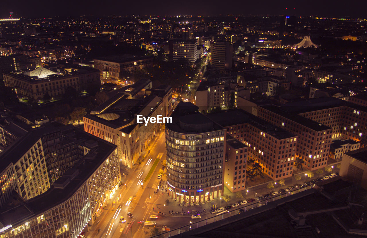 High angle view of illuminated cityscape against sky at night