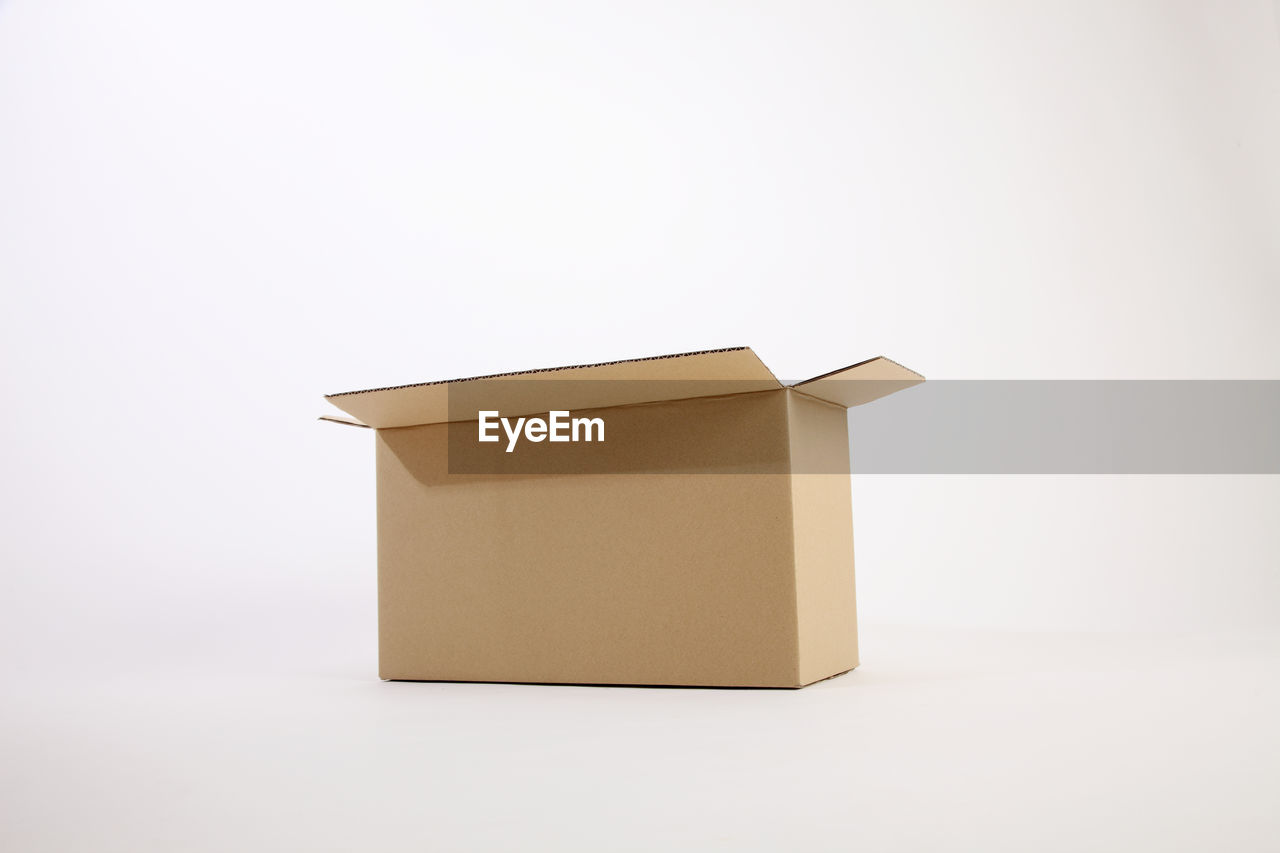 Close-up of cardboard box over white background