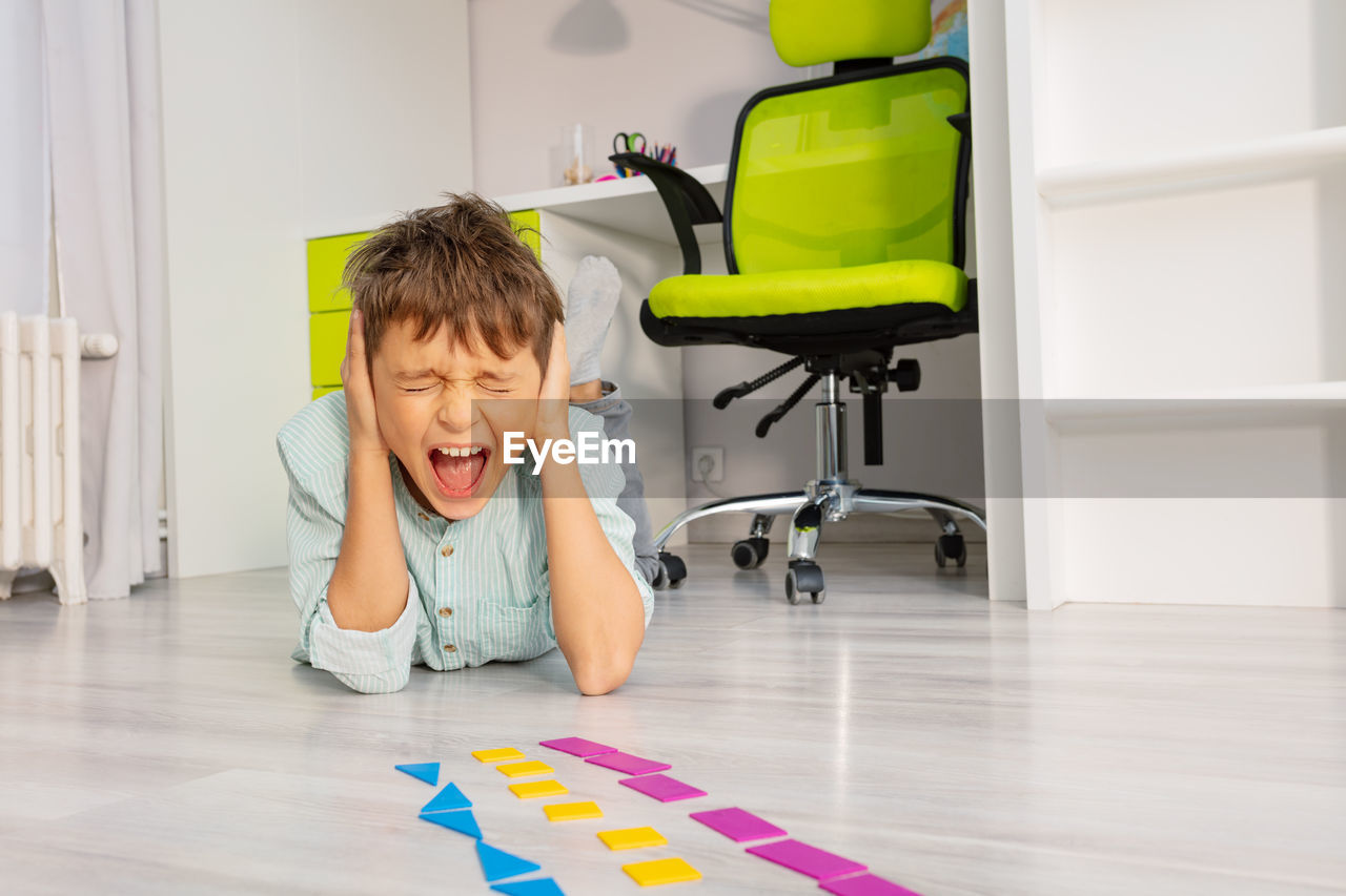 portrait of boy playing with toys at home
