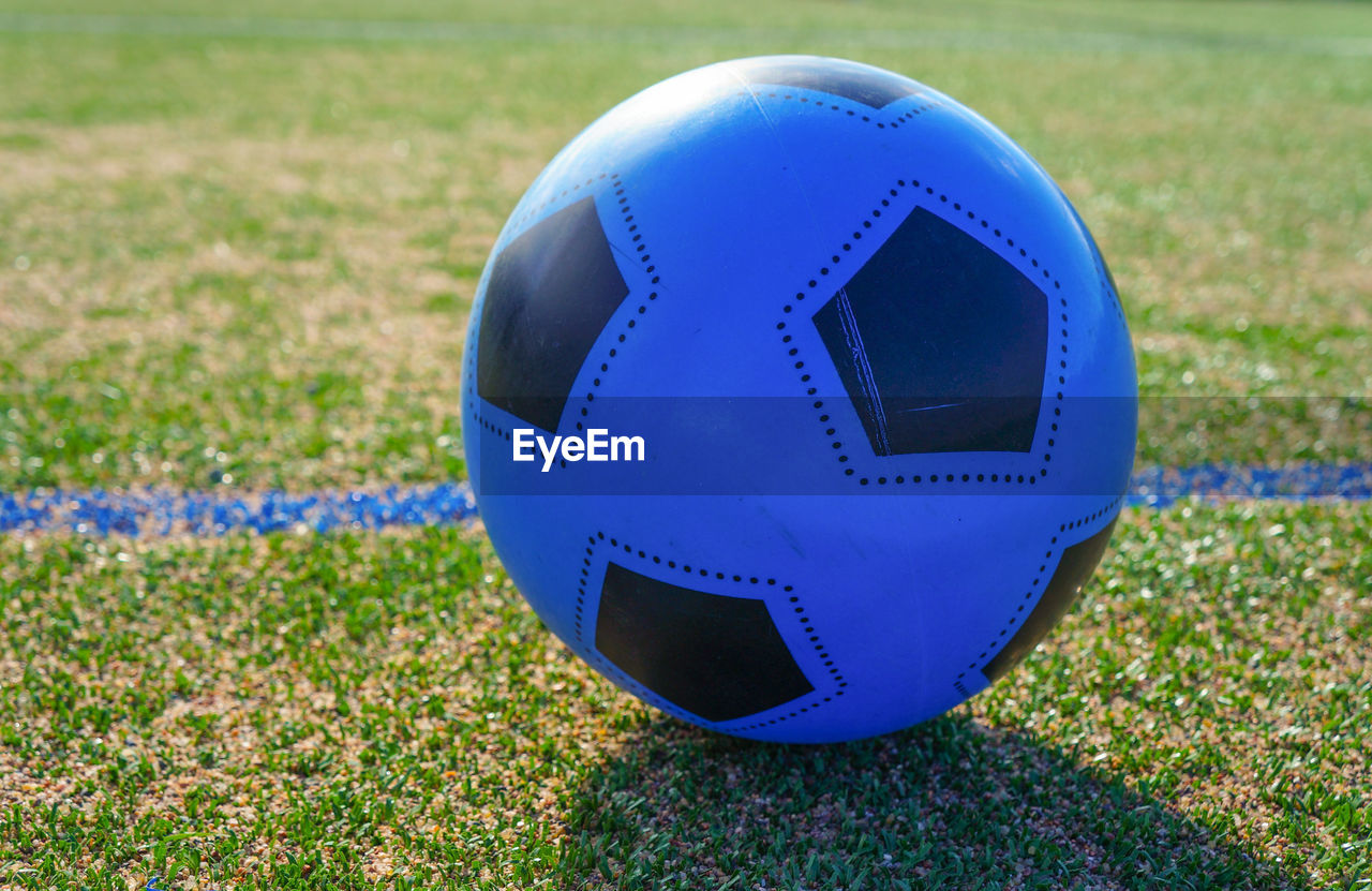 CLOSE-UP OF BALL ON SOCCER FIELD