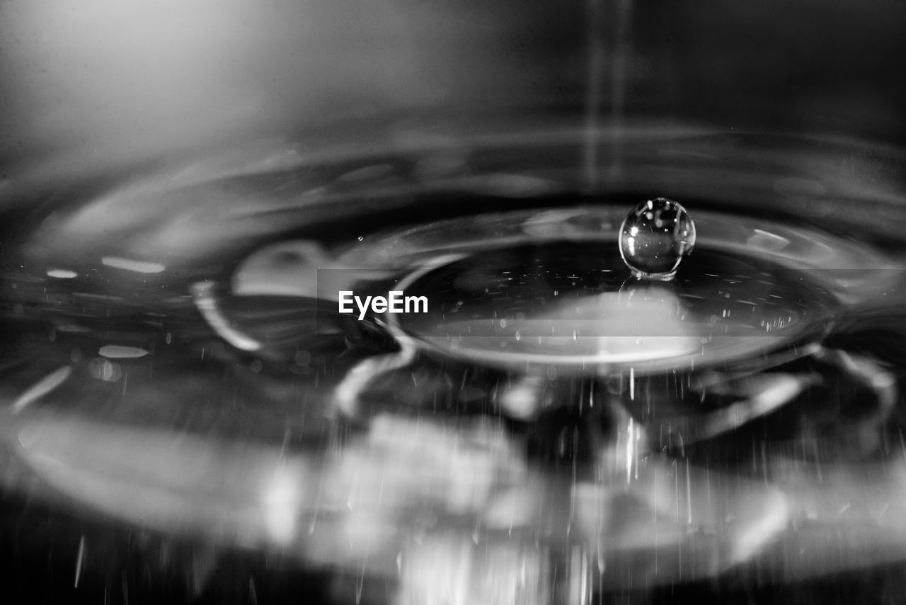 CLOSE-UP OF WATER DROP FALLING IN METAL