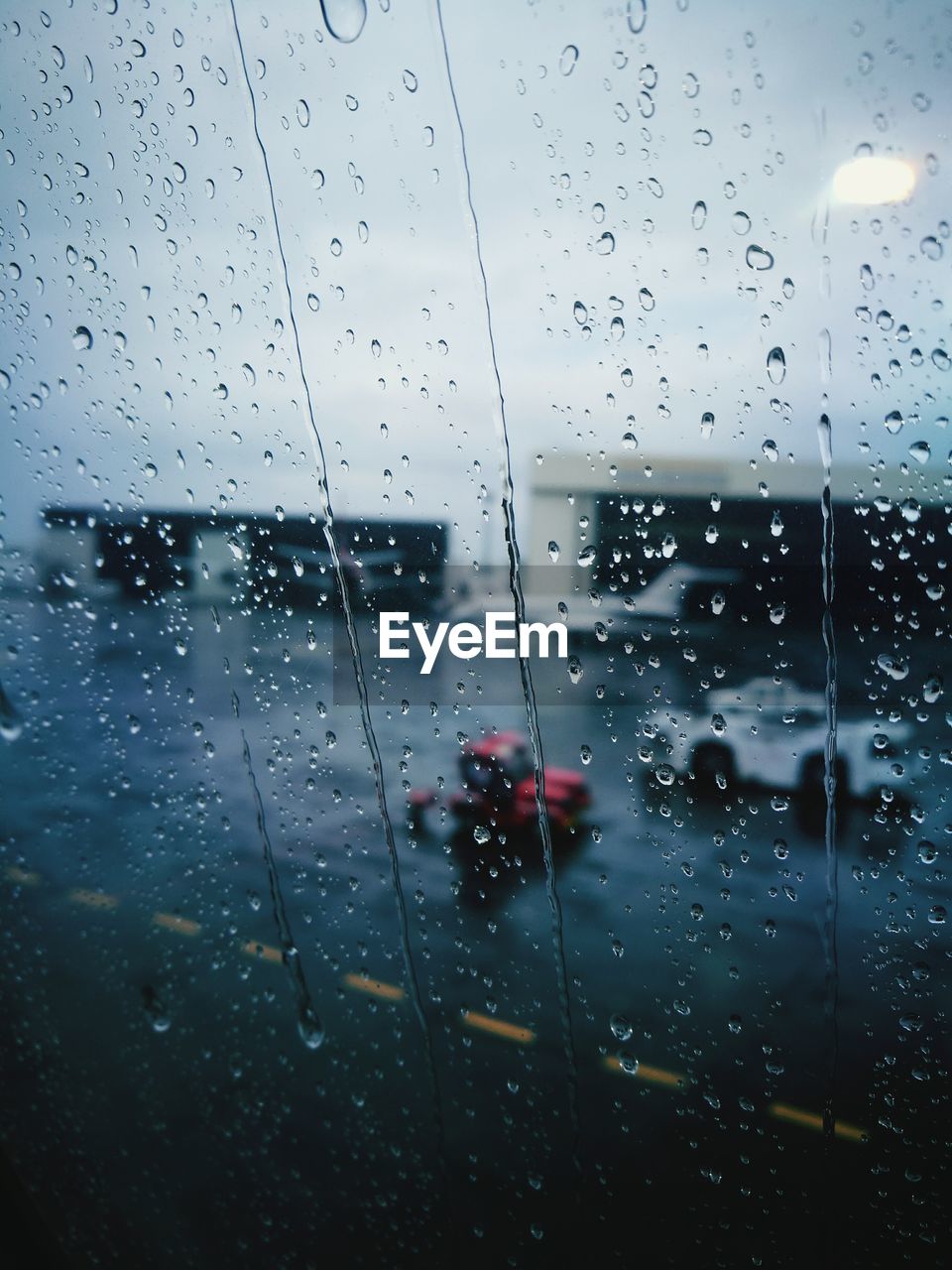 CLOSE-UP OF WET WINDOW WITH RAIN DROPS