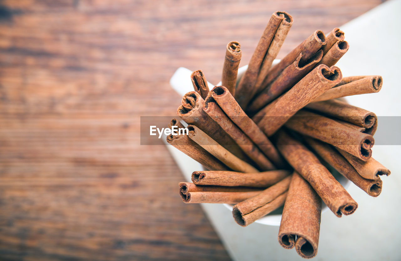 High angle view of cinnamons in cup on table