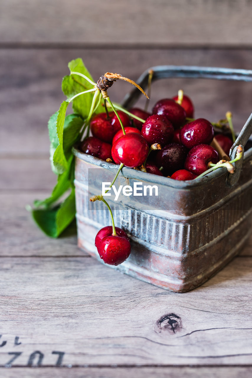 Close-up of cherries in basket on table