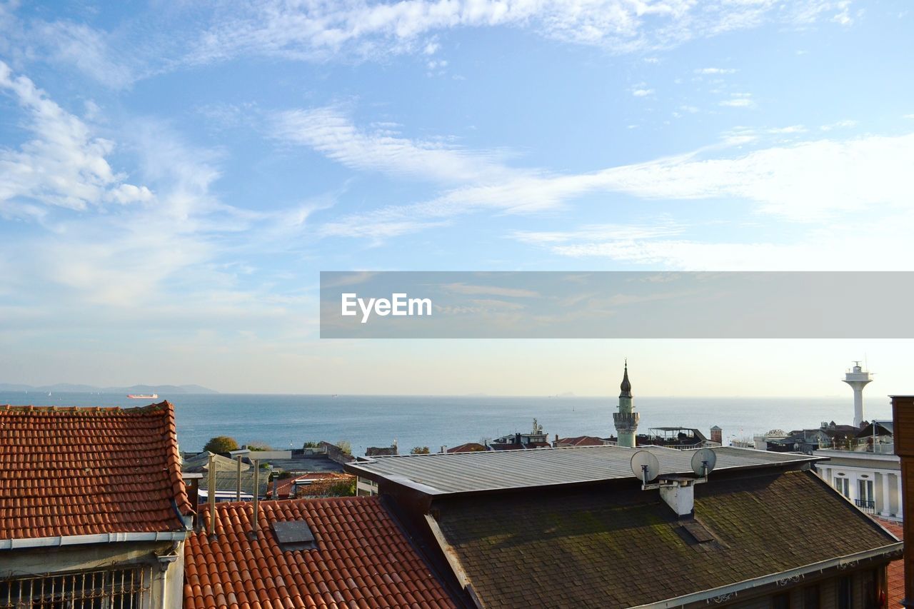 Scenic view of sea against sky in city