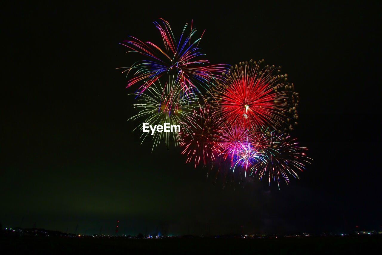 Low angle view of firework display at night