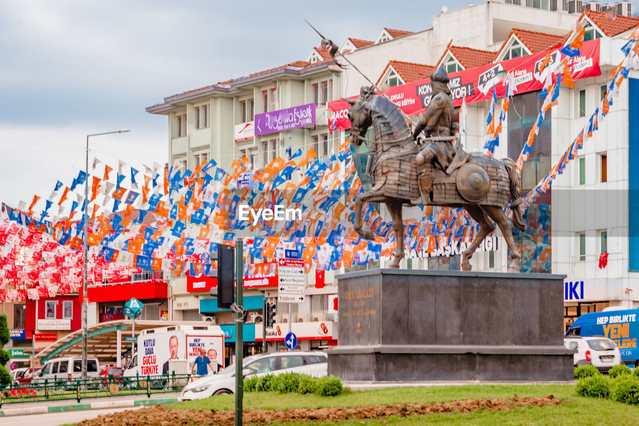 LOW ANGLE VIEW OF FLAGS HANGING ON BUILDING