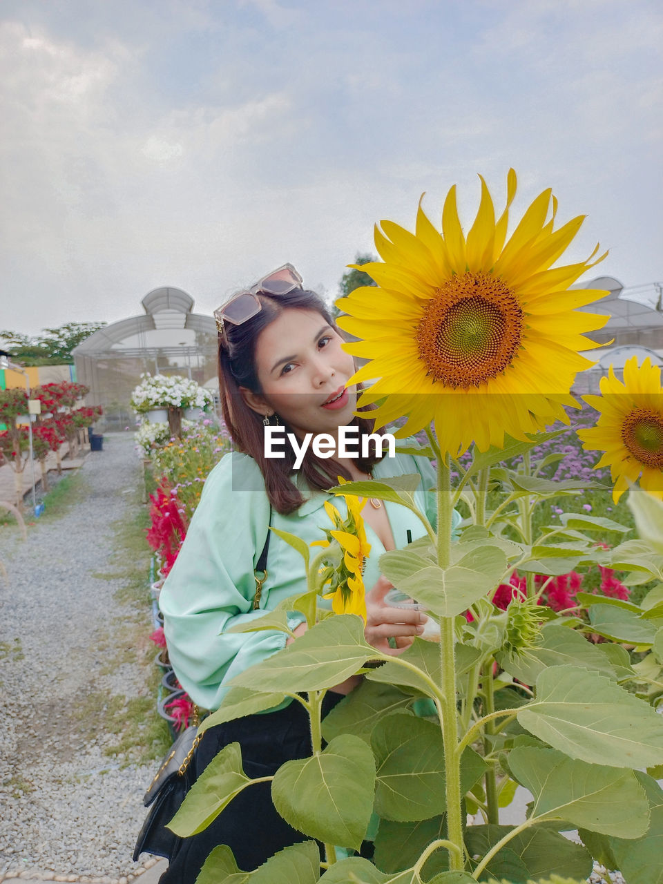 Young woman standing amidst flowers