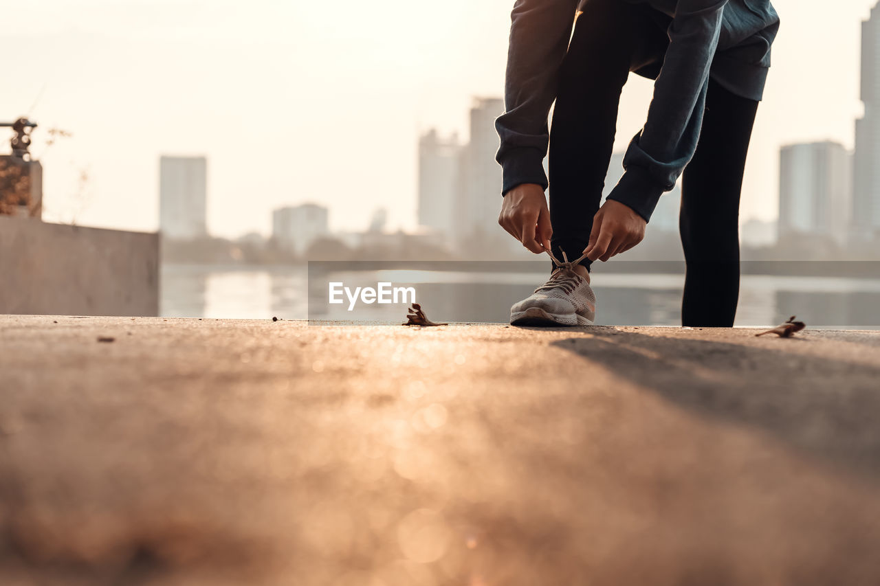 LOW SECTION OF MAN WITH CITY ON BACKGROUND