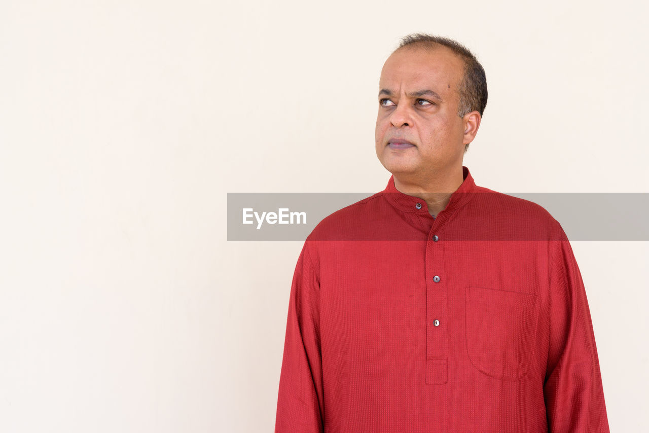 MAN LOOKING AWAY OVER WHITE BACKGROUND