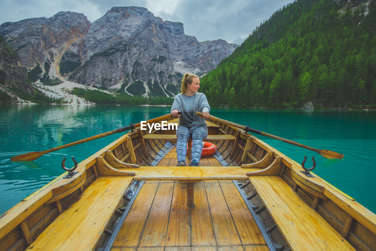 Woman rowing boat in lake