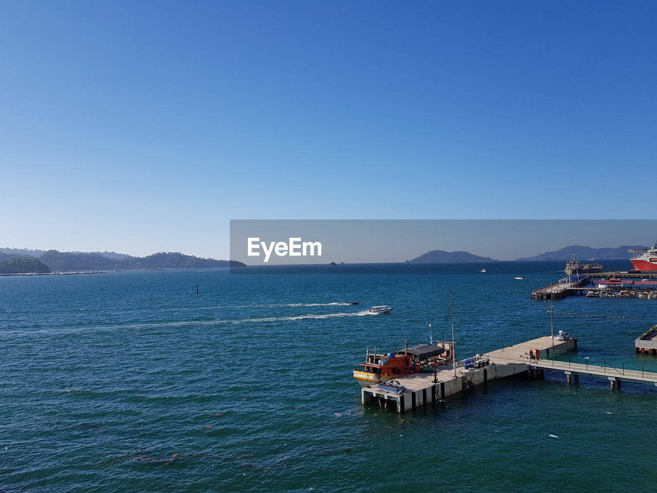 Scenic view of sea against clear blue sky