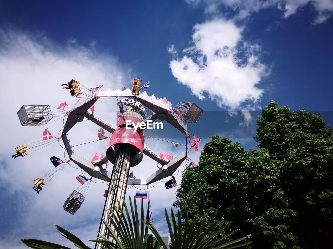 Low angle view of chain swing ride against sky