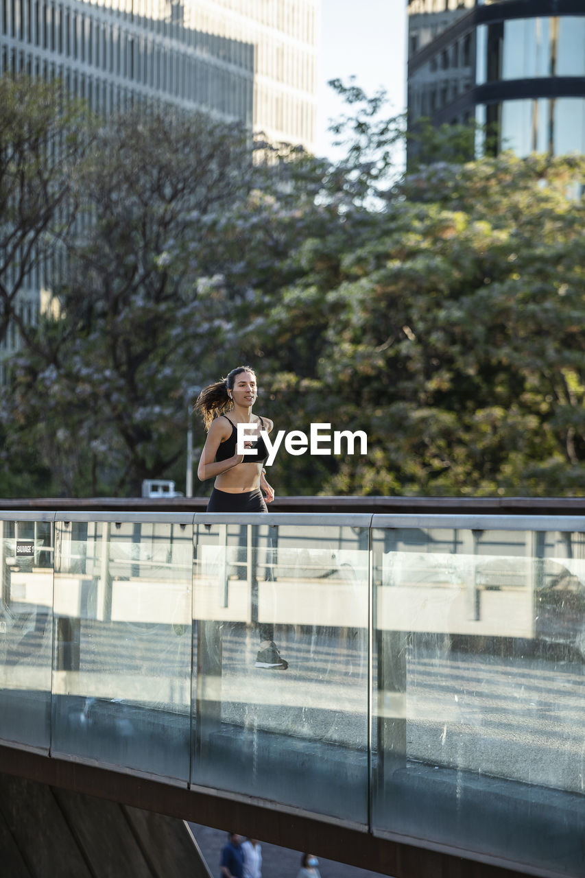 Woman jogging on footbridge