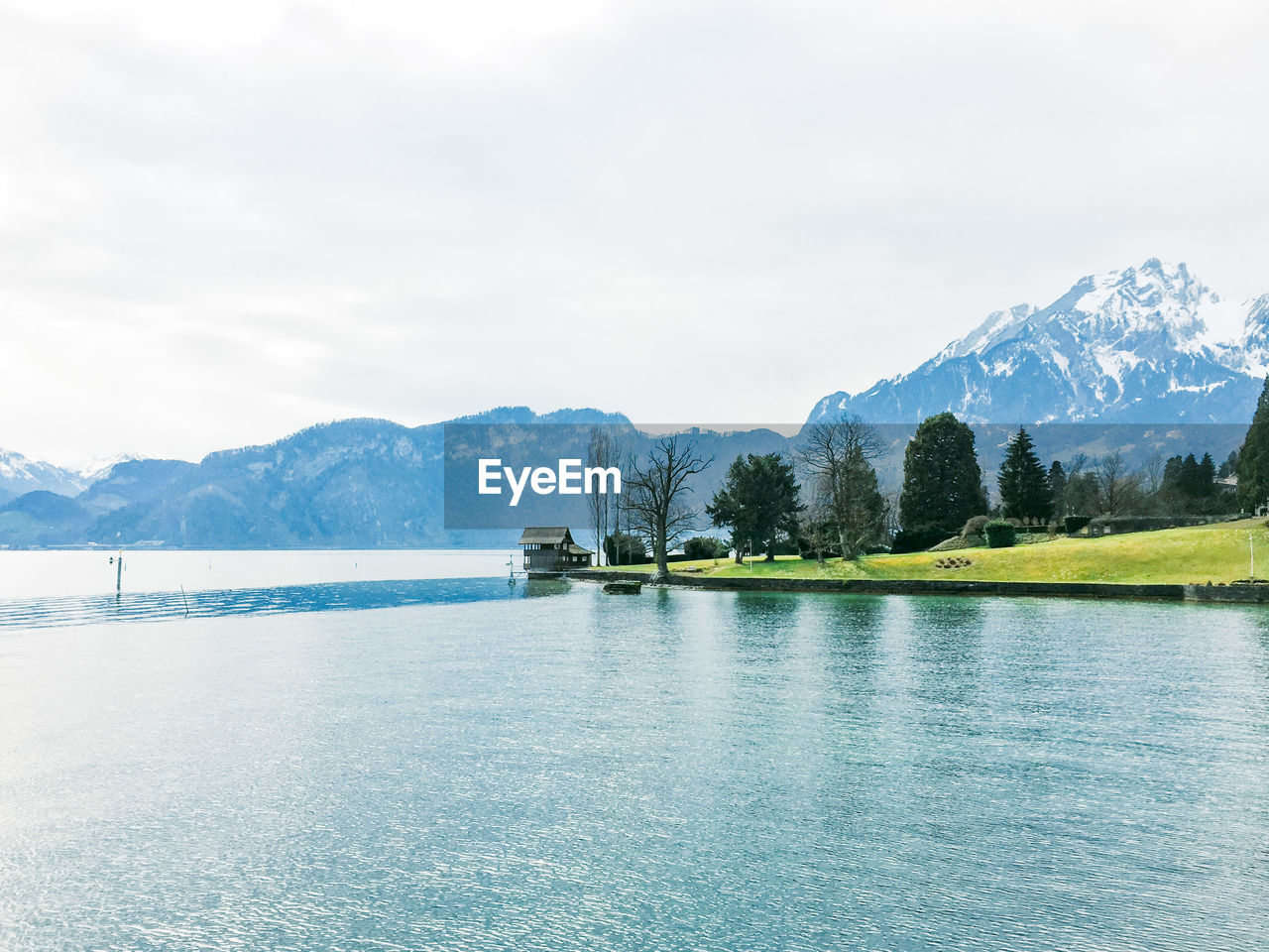 Scenic view of lake and mountains against sky